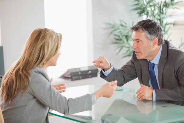 A blonde businesswoman and a mature businessman having an argument in an office-2